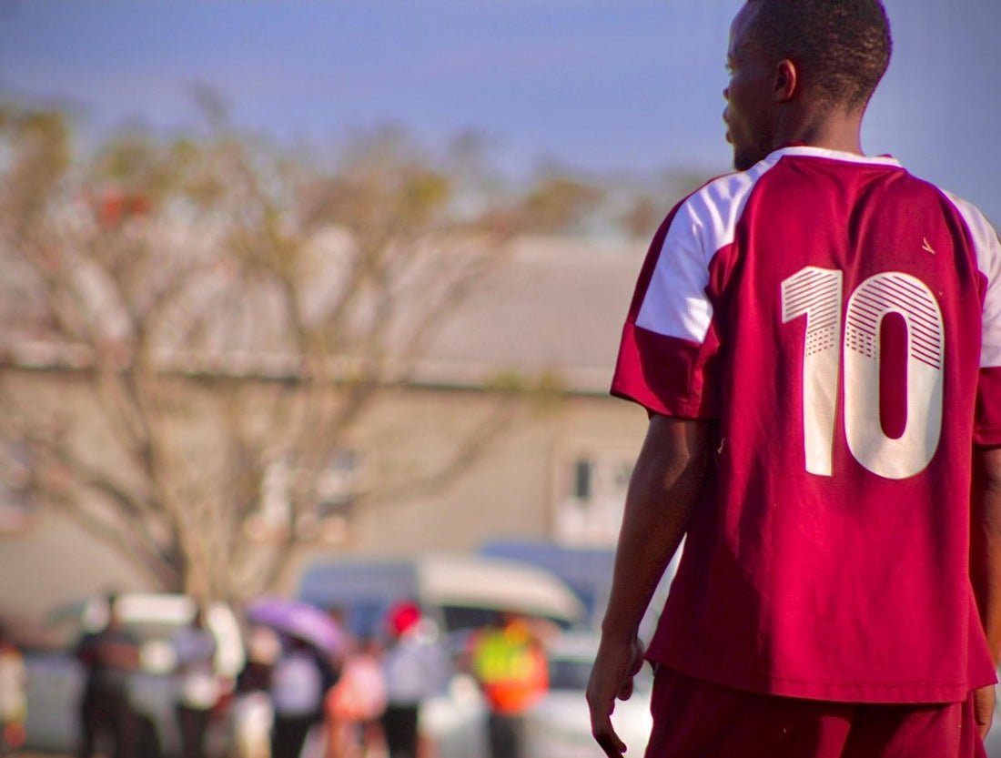 a man in a red and white soccer uniform