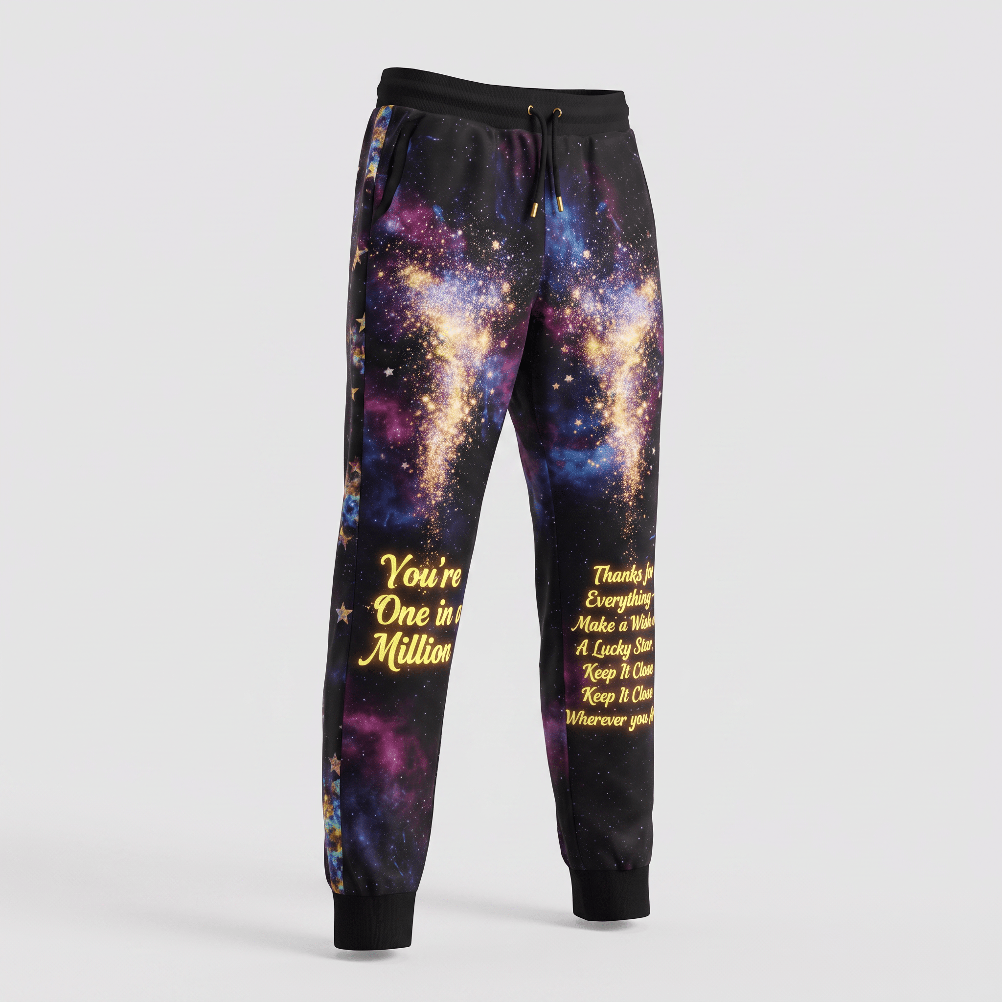 Black sweatpants featuring vibrant galaxy space print and yellow text on the legs.