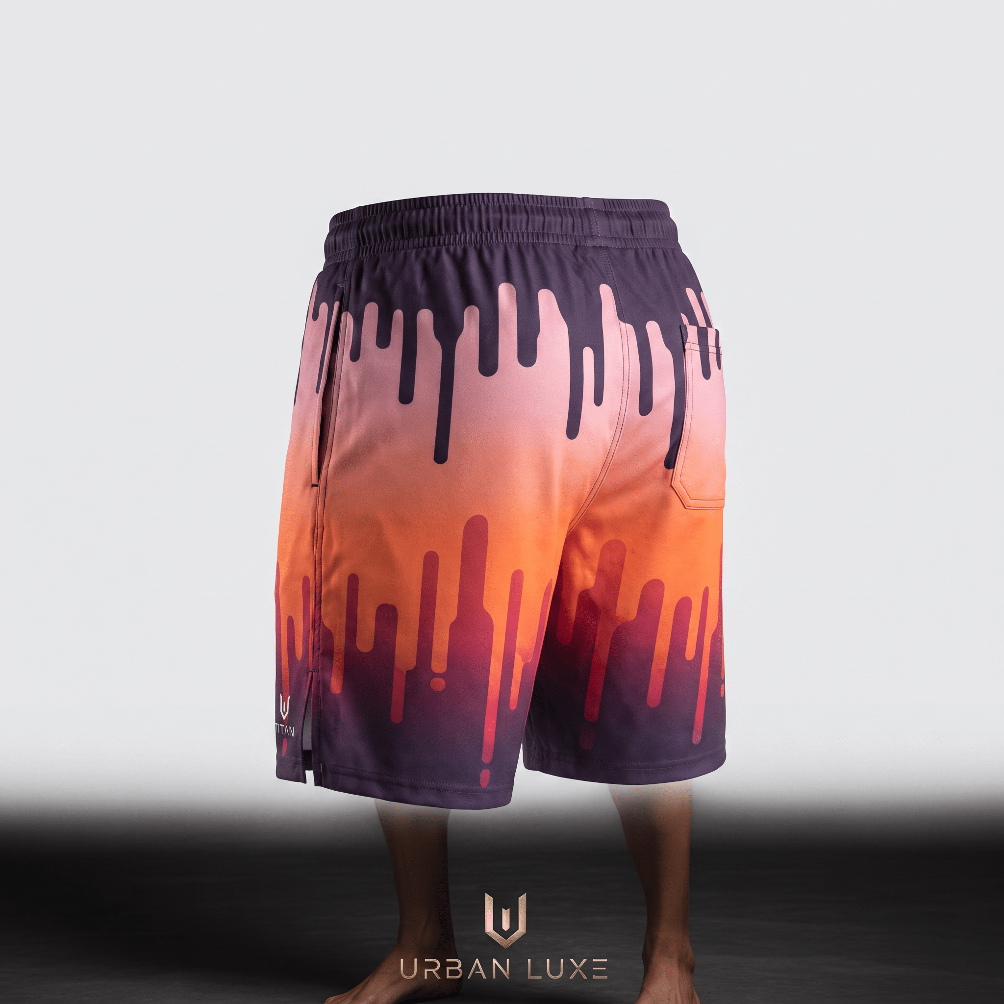 Back view of purple and orange athletic shorts featuring a vibrant sunset drip gradient design.