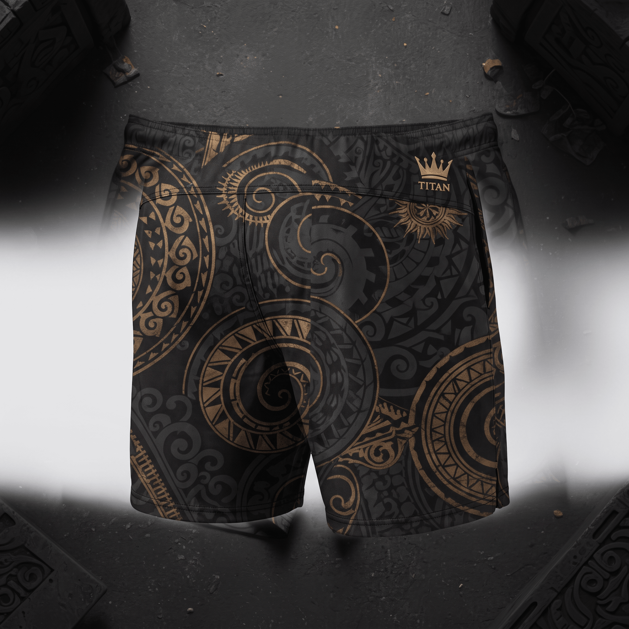 Black and gold Titan athletic shorts featuring a detailed tribal swirl pattern.