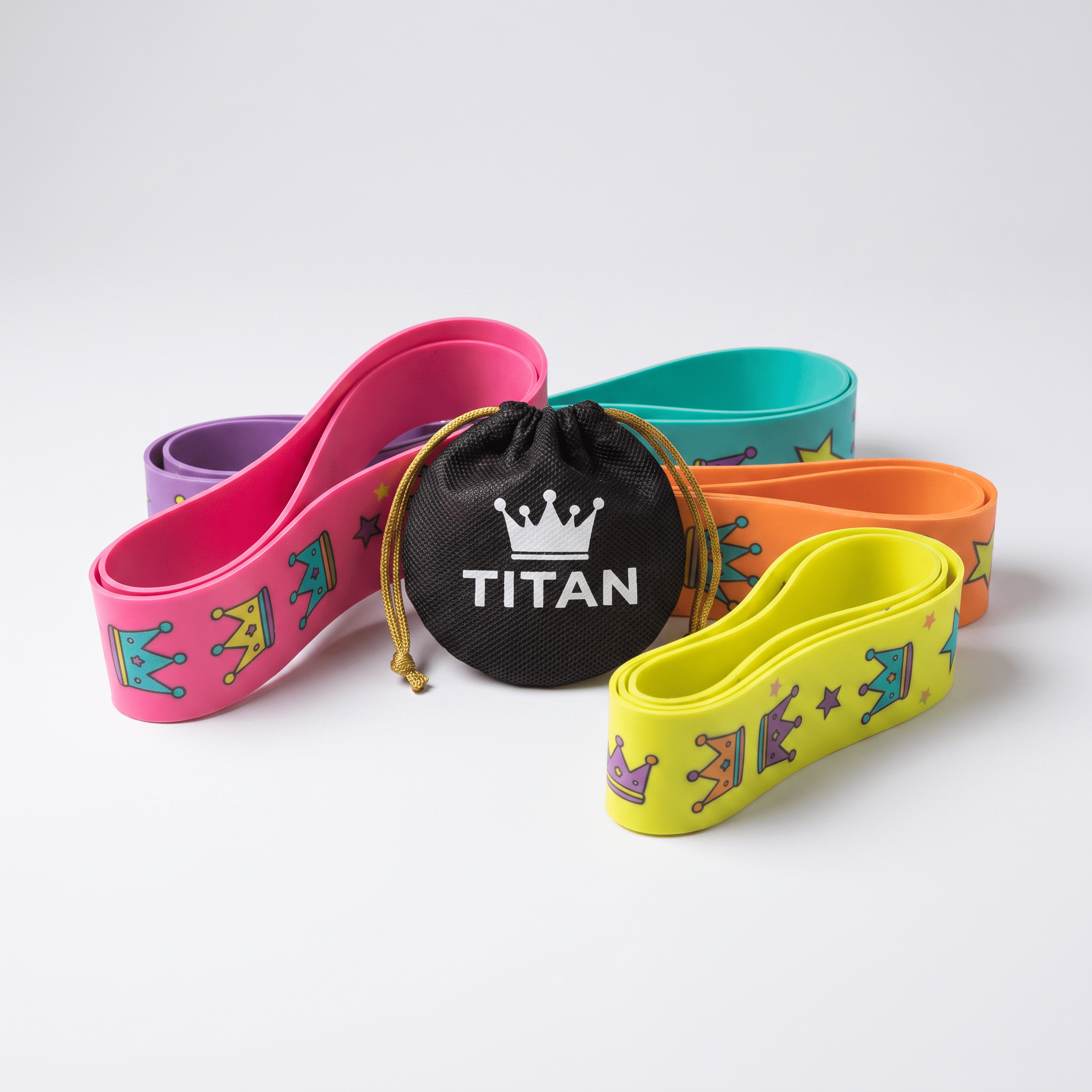 Colorful Titan resistance bands with crown patterns arranged around a black branded carry bag.