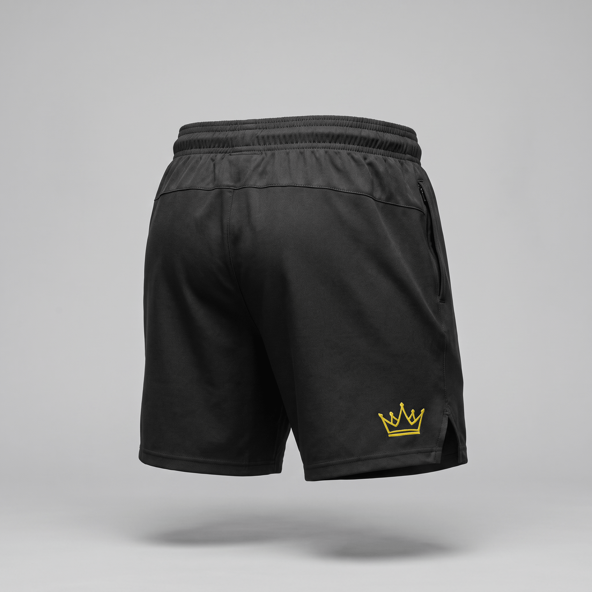 Back view of black athletic shorts with an elastic waistband, side zipper pocket, and yellow crown logo.