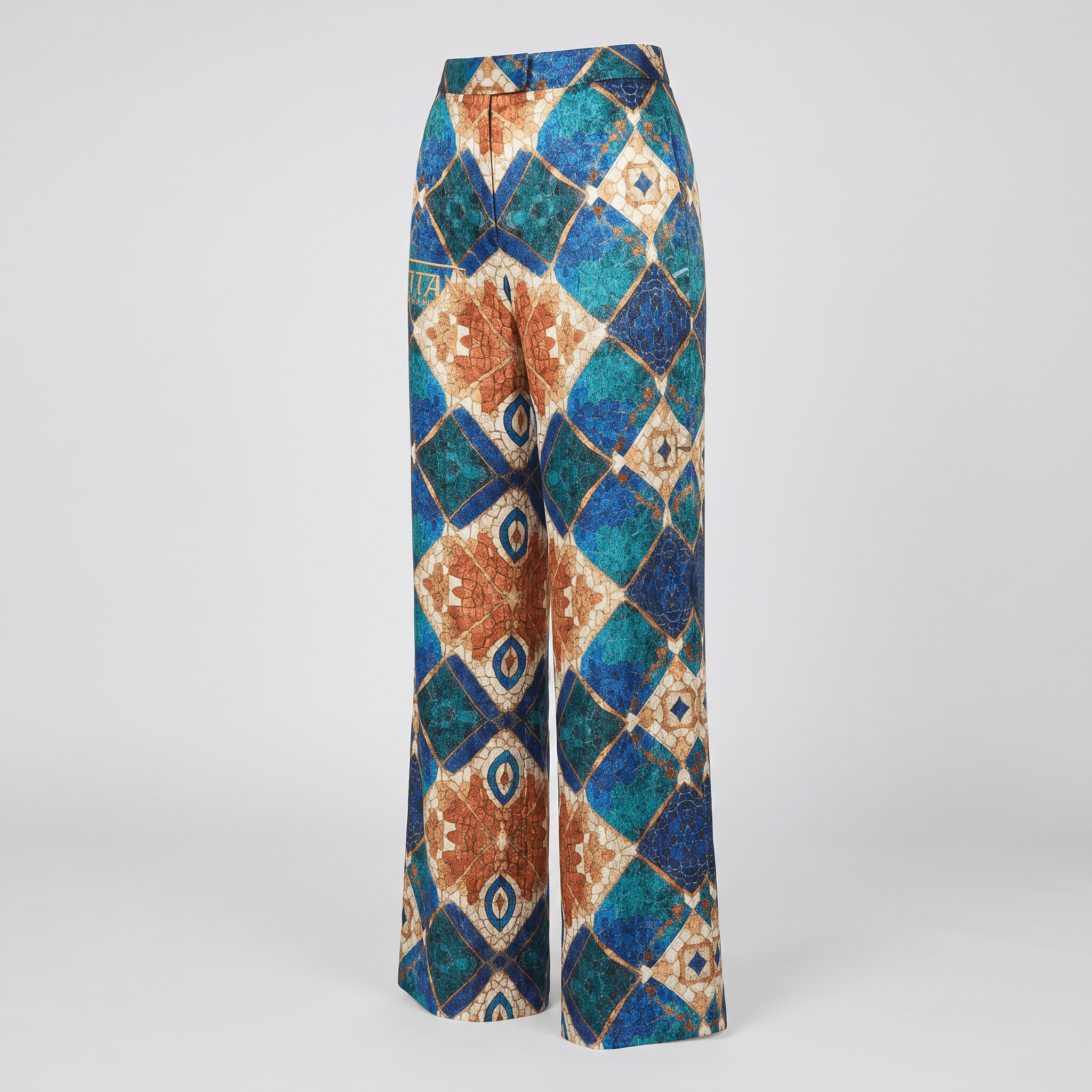 Wide-leg trousers featuring a geometric diamond mosaic print in blue, teal, and tan tones.