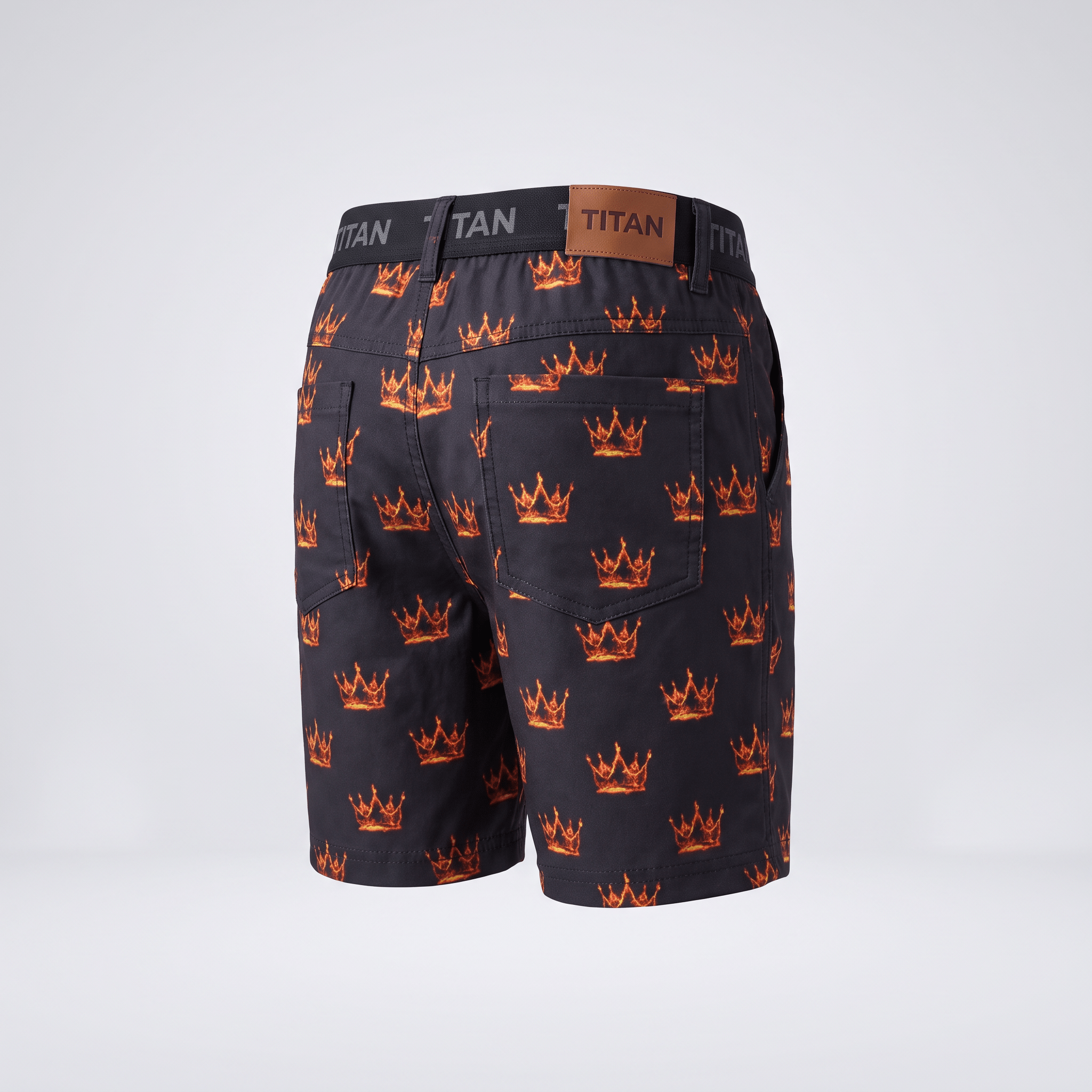 Back view of black Titan shorts with an all-over flaming crown print and brown leather waistband patch.