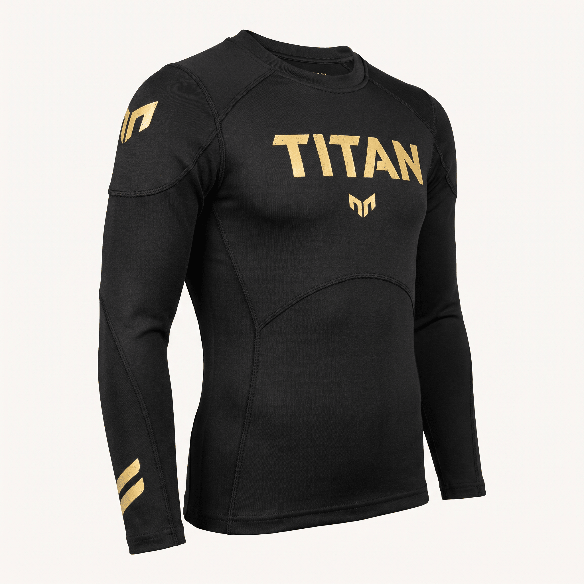 Black long-sleeve compression rash guard with gold Titan branding across the chest and shoulder logos.