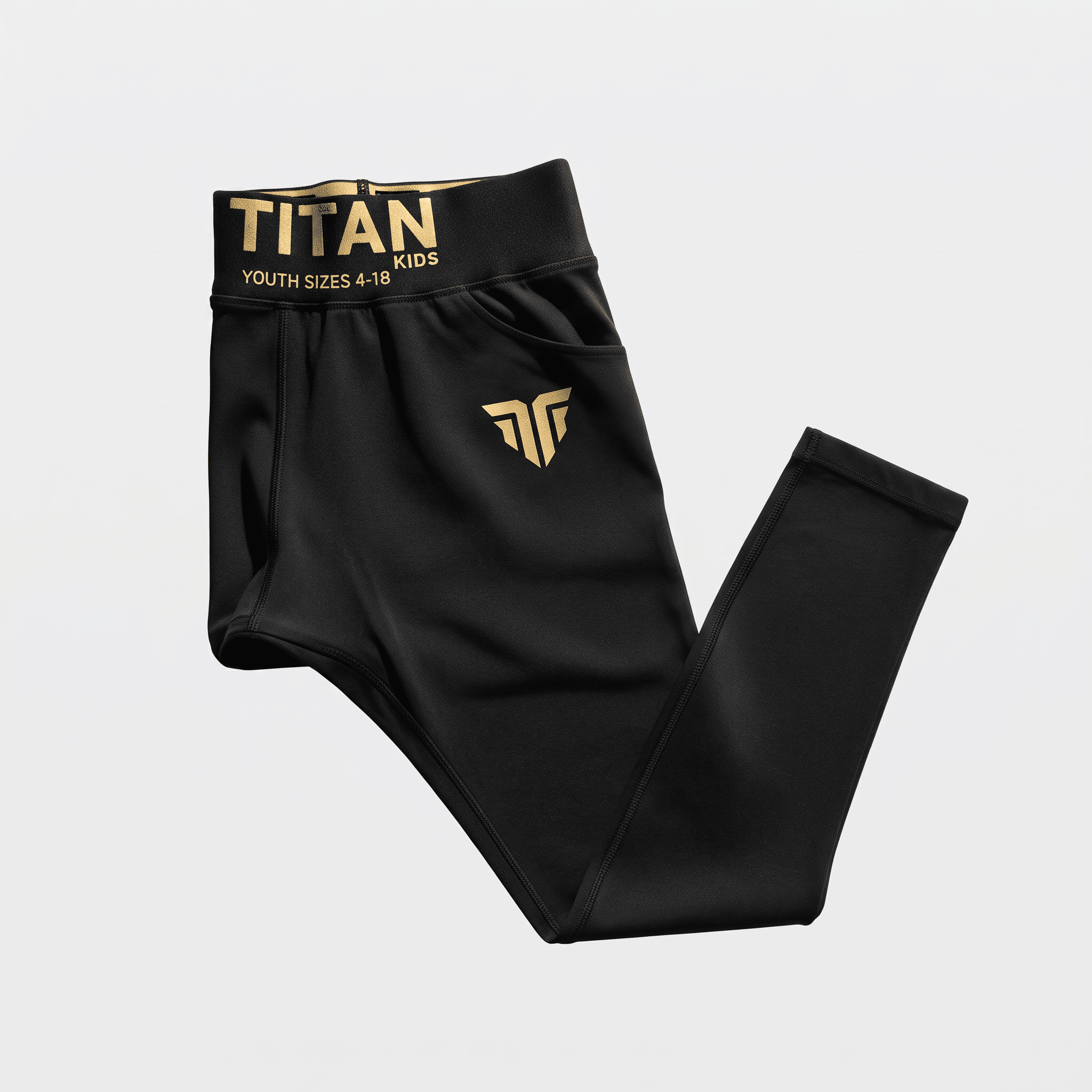 Black youth athletic tights with gold Titan waistband lettering and logo on white background.