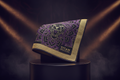 TITAN gold and purple microfiber gym towel featuring an intricate roaring lion mandala design and logo on a pedestal.