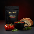 TITAN Clean Eating Protein Soup Tomato Basil — side-angle mug shot with rich red tomato basil soup, fresh basil and rustic bread