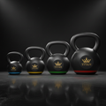 TITAN Kettlebell Set — Five matte black cast iron kettlebells with gold crown logo and color-coded weight rings
