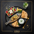 TITAN Greek Lemon Herb Sea Bream Breakfast Plate flat lay dark luxury