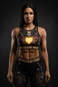 Titan Sport crop top and leggings with crown, rose, and glowing heart graphic. Text: "MY PAIN IS MY POWER."