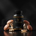 Black bottle of Titan Agaricus Bliss with gold logo, surrounded by mushrooms, capsules, and powder on black surface.
