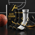 Three-pack TITAN Elite Cushion basketball socks in black and white with gold accents, displayed in packaging.