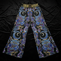 TITAN Crown Edition palazzo pants featuring blue and purple owl and crescent moon tattoo art on a black background.