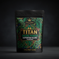 TITAN Greens Powder pouch in black with ornate green tropical foliage, gold crown logo, and bold white text.
