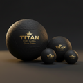 Four black massage balls of varying sizes with gold Titan Sport Global Crown Edition logos and textured surfaces.