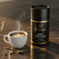 Black canister of Titan NAD+ coffee creamer next to a steaming latte on a dark marble surface with gold coffee beans.