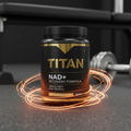 Black TITAN NAD+ supplement tub with gold lettering, encircled by glowing orange rings on a dark gym floor.