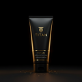 Matte black tube of Titan Performance Hand Cream with gold logo and text, set against a dark background with gold dust.