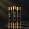Three black and gold TITAN Sport lip balm tubes with sun logo, vertically aligned on a dark, reflective surface.