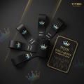 TITAN Crown Edition black resistance bands with holographic crown logos, a mesh carry bag, and workout guide booklet.